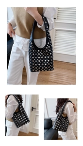 Detailed views of a trendy black shoulder bag featuring silver rivets and wide strap