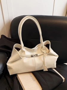 Minimalist beige oversized tote bag with pleated texture and silver twist lock detail