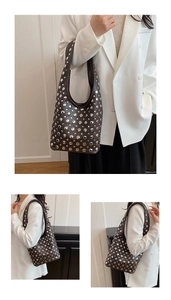 Close-up of brown matte leather shoulder bag with silver round rivets decoration