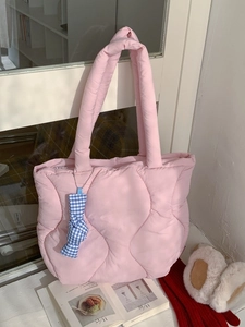 Pink quilted puffer tote bag with blue checkered bow accessory for casual style