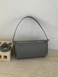 Chic dark gray cylindrical pillow bag with lychee texture and adjustable shoulder strap