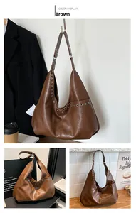 Detail of brown hobo bag featuring silver metal eyelet studs and side pocket design