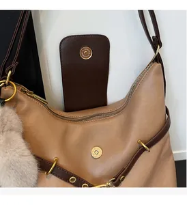 Detail of premium golden hardware and magnetic snap closure on light brown tote bag