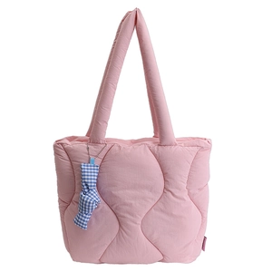 Pink quilted tote bag with wave stitching and blue checkered bow charm for women