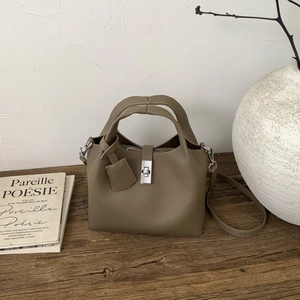 Close-up of litchi grain leather bucket bag with silver buckle and detachable shoulder strap