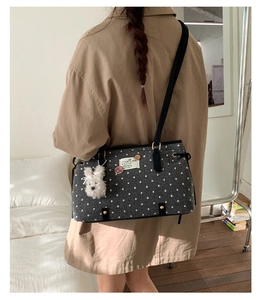 Detailed view of gray felt tote bag with white polka dots and plush rabbit accessory