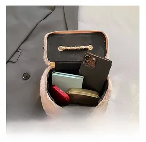 Macro detail of plush pink bucket bag interior showing capacity for makeup and phone