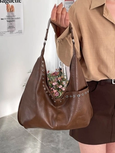 Minimalist large brown hobo bag with silver rivet details and adjustable shoulder strap