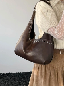 Retro dark brown leather hobo shoulder bag with silver eyelet details on minimalist model