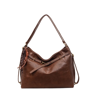 Brown large capacity leather tote bag with vintage texture and woven tassel detail