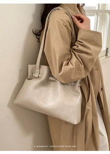 Detail of soft leather oversized tote bag with adjustable drawstring strap on shoulder