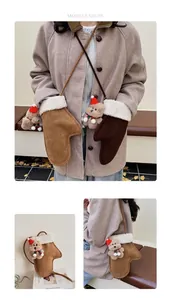 Detail of plush Christmas gloves with a 3D teddy bear and warm faux suede texture