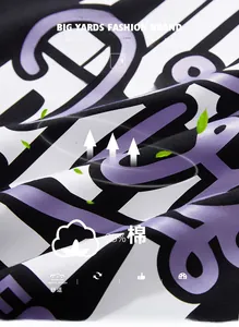 Gros plan du tissu en coton noir avec des graphismes imprimés en violet et blanc