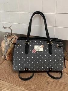 Grey polka dot felt tote bag with cartoon cat patch and black leather handles
