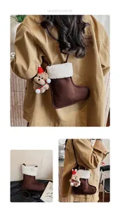 Detail view of suede Christmas stocking bag with plush teddy bear and shearling trim