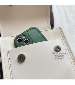 Detail of front magnetic pocket on cream tote bag showing easy storage for a mobile phone