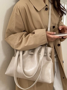 Chic pleated off-white tote bag with adjustable shoulder strap and drawstring detail