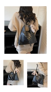 Detail of black faux leather tote with golden hardware and plush bunny pendant charm