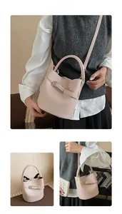 Detail view of pink lychee pattern bucket bag with adjustable strap and metal hardware