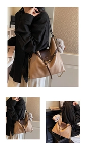Detail of khaki and brown tote bag with gold chain strap and grey plush rabbit pendant