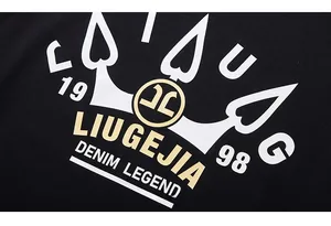 Detail of premium black knit fabric with vintage crown print and gold lettering