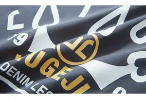 Detailed macro view of the premium screen-printed lettering on dark grey cotton fabric