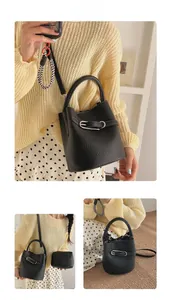 Detail of black lychee grain bucket bag featuring silver buckle and detachable strap