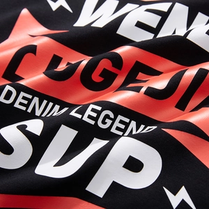 Close-up of black cotton long sleeve T-shirt featuring red and white street style graphics
