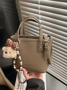 Deep khaki bucket bag with lychee texture leather and a cute teddy bear charm