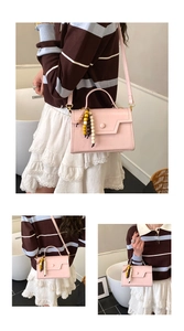 Pink leather crossbody bag featuring unique colorful wood bead fringe and minimalist square design