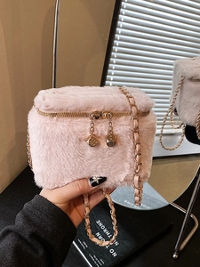 Pink plush mini box bag with gold chain strap and decorative metal dice pendant
