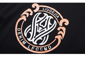 Detail shot of the LIUGEJIA DENIM LEGEND pink and white logo print on a black T-shirt