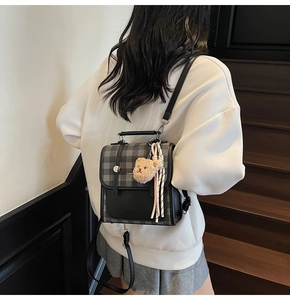 Mini plaid backpack for women with teddy bear charm shown worn on model back