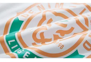 Macro shot of cotton fabric featuring a retro orange and green denim printed logo