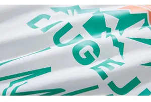 Close-up of high-quality white cotton fabric with vibrant green and orange printed graphics