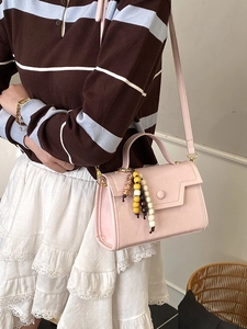 Fashionable pink faux leather crossbody bag for women with wooden bead charm detail