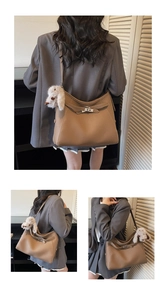 Detail view of brown pebbled leather shoulder bag with buckle and plush rabbit charm