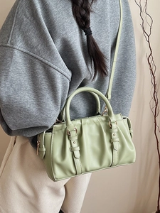 Light green pleated leather handbag with gold metal accents and detachable crossbody strap