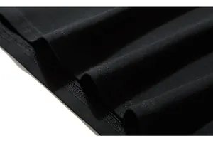 Detail of double-needle stitching on the hem of a black cotton knit long sleeve t-shirt