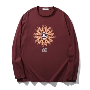 Burgundy long sleeve crew neck t-shirt with orange sun print in a flat lay display