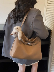 Chic brown litchi leather shoulder bag with silver clasp and plush bunny accessory