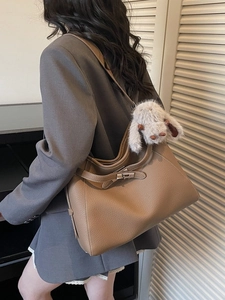 Brown litchi leather shoulder bag with silver buckle and plush rabbit charm