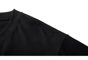 Detail of black crew neck T-shirt with cloud jacquard fabric and neckline stitching