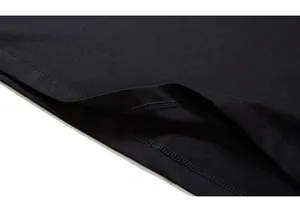 Close-up of the double-needle stitched hem on a high-quality black cotton t-shirt