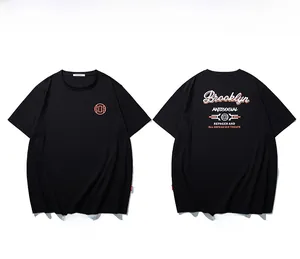 Flat lay of black cotton T-shirt featuring Brooklyn graphic and orange circular totem prints