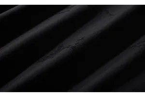Detailed macro shot of premium black knitted cotton fabric with a ribbed texture and distressed finish