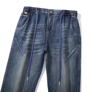 Relaxed fit dark blue washed joggers for men with elastic drawstring waist and whiskering
