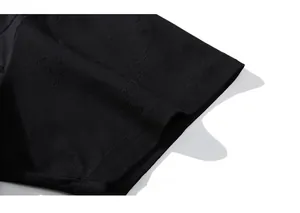 Detail of black jacquard fabric texture and stitching on oversized men's cotton t-shirt