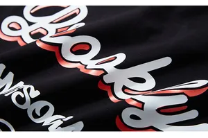 Macro shot of 3D rubberized letter print on high-quality black knitted cotton T-shirt