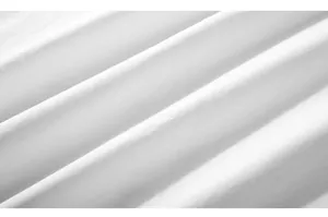 Macro view of white textured pique fabric with fine vertical stripe knitting patterns